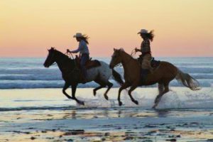 Two Cowgirls on Beach