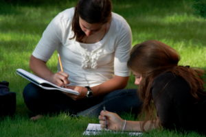 Two Girls Studying on the Grass